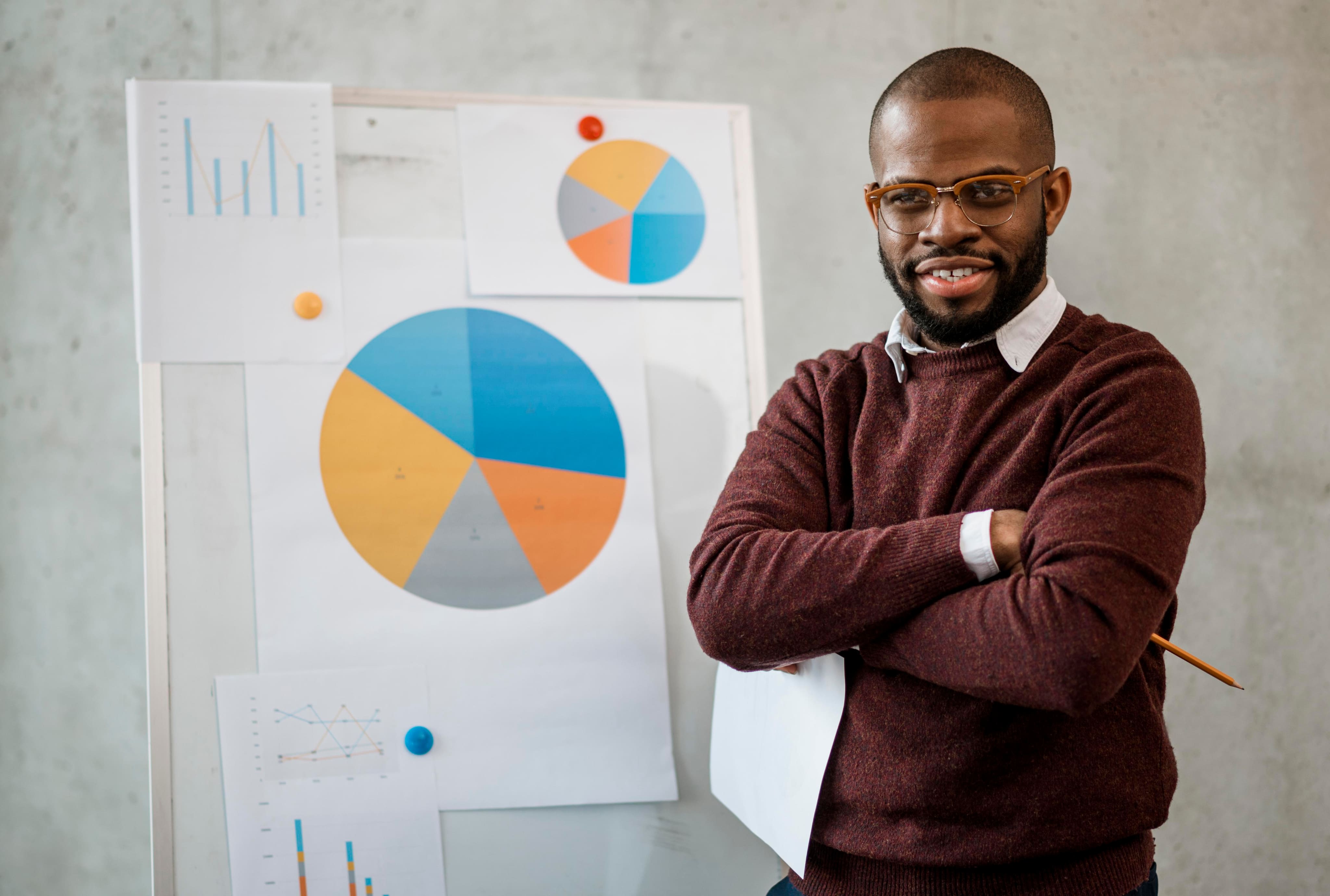 man in front of a board doing market research analysis